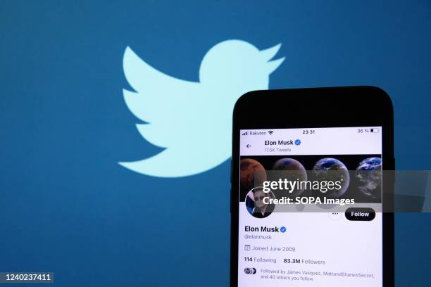 In this photo illustration, Elon Musk's twitter account is seen displayed on a smartphone with a background of the twitter logo. Rumours have emerged...