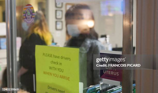 Sign reading "Mind Your Own Uterus" is taped on the check-in window at the Hope Medical Group for Women in Shreveport, Louisiana, April 19, 2022. -...