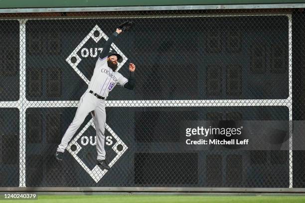 Charlie Blackmon of the Colorado Rockies makes a leaping catch on a ball hit by Alec Bohm of the Philadelphia Phillies in the bottom of the sixth...
