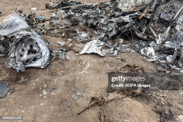 : Skeletons of dead Russian military pilots among the wreckage of a downed and burnt helicopter in the middle of a field near the village of Makariv....
