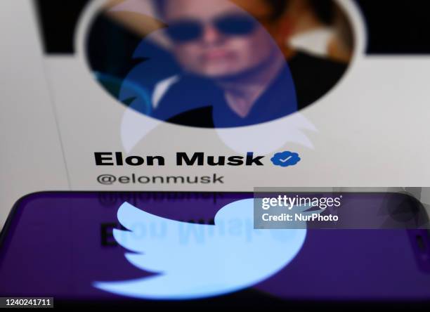 Twitter logo displayed on a phone screen and Elon Musk's Twitter account displayed on a laptop screen are seen in this illustration photo taken in...