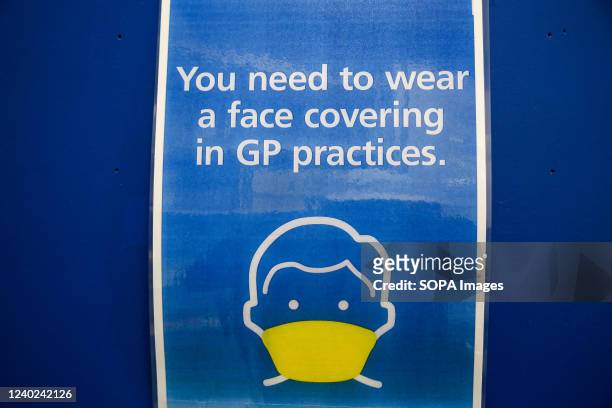 You need to wear a face covering in GP practices.' sign displayed at a doctors surgery.