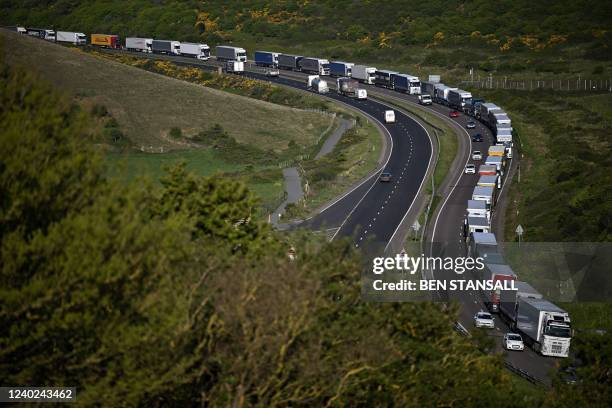 Freight lorries and HGVs queue on the A20 road towards the Port of Dover on the south-east coast of England, on April 26, 2022.