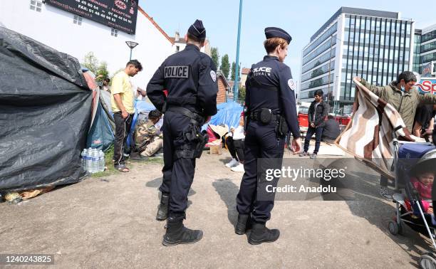 French police officers patrol the park as nearly 150-200 irregular migrants including families with children, Iran, Morocco and mostly from...