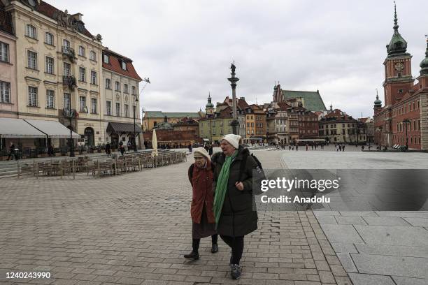 Women walk as daily life continues in Stare Mesto town of Warsaw, Poland on April 25, 2022.