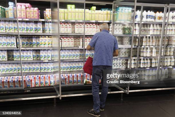 Shopper browses cartons of milk in a refrigerated cabinet inside a Shufersal Ltd. Supermarket in Herzlia, Israel, on Monday, April 25, 2022. Delek...