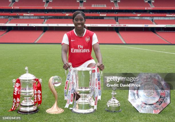 Anita Asante of Arsenal poses with the trophies FA Cup, UEFA Cup, League Cup, Premier League Trophy and the Community Shield before the Womens...