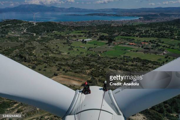 An aerial bview of Hazel Kaya, an adrenaline junkie, sitting on a wind turbine in Turkiye's Izmir on April 20, 2022. Despite her phobia of heights,...