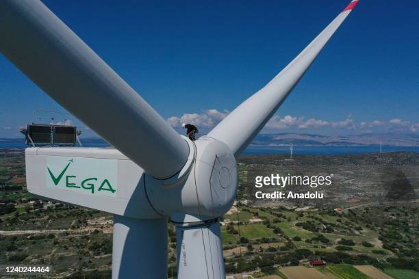 Hazel Kaya, an adrenaline junkie, sits on a wind turbine in Turkiye's Izmir on April 20, 2022. Despite her phobia of heights, Hazel Kaya, an...