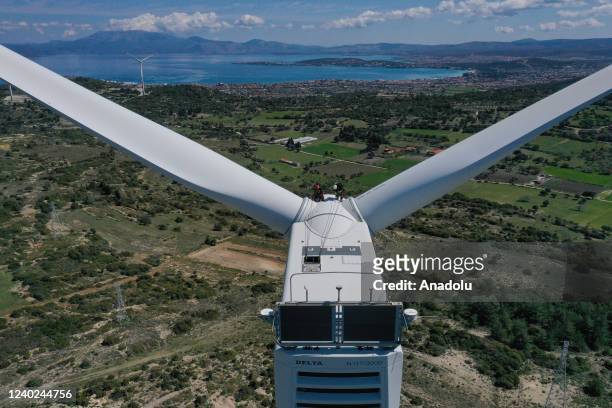 Hazel Kaya, an adrenaline junkie, sits on a wind turbine in Turkiye's Izmir on April 20, 2022. Despite her phobia of heights, Hazel Kaya, an...