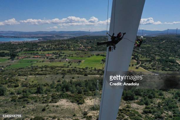 Hazel Kaya, an adrenaline junkie, climbs a wind turbine in Turkiye's Izmir on April 20, 2022. Despite her phobia of heights, Hazel Kaya, an...