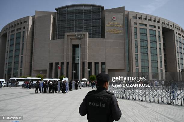 Turkish anti riot police stand outside the Istanbul courthouse during a protest against a Turkish court decision to sentence leading activist Osman...