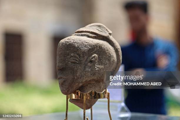 Newly-discovered stone statuette over 4,500 years old depicting the face of an ancient goddess, is displayed during a press conference at the...