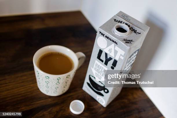 Symbolic photo on the subject of oat milk in coffee. A pack of Oatly Barista oat milk stands next to a cup of coffee on April 26, 2022 in Berlin,...