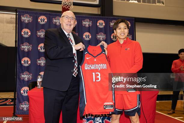 Mike Thibault and Rui Machida hold up the Washington Mystics jersey during an introductory press conference on April 25, 2022 at Entertainment and...