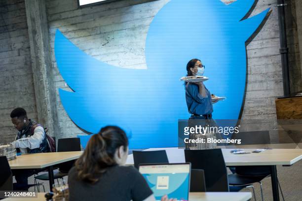 An employee carries plates of food at Twitter headquarters in San Francisco, California, U.S., on Thursday, March 17, 2022. Shares of Twitter...