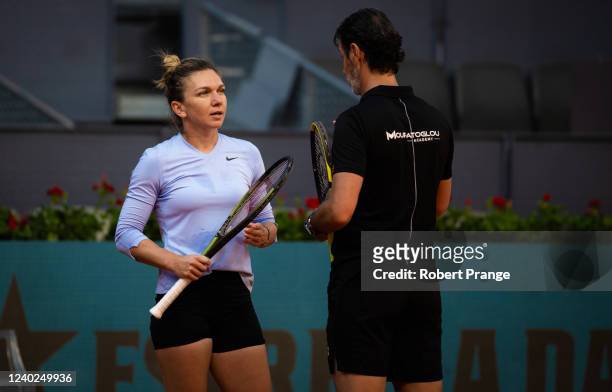 Simona Halep of Romania with coach Patrick Mouratoglou during practice ahead of the Mutua Madrid Open at La Caja Magica on April 26, 2022 in Madrid,...