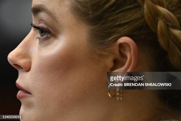 Actress Amber Heard listens in the courtroom at the Fairfax County Circuit Courthouse in Fairfax, Virginia, April 26, 2022. - Actor Johnny Depp sued...