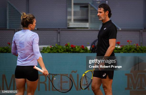 Simona Halep of Romania with coach Patrick Mouratoglou during practice ahead of the Mutua Madrid Open at La Caja Magica on April 26, 2022 in Madrid,...