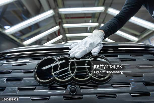 An employee conducts quality control checks on an Audi Q4 e-tron electric vehicle on the assembly line at the Volkswagen AG electric automobile plant...
