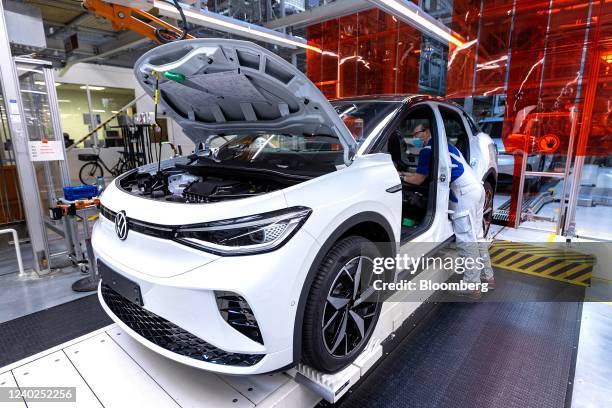 Employees fix the seats of a Volkswagen AG ID.5 electric sports utility vehicle on the assembly line at the automaker's electric automobile plant in...