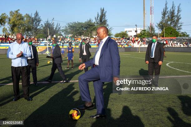 President of the Confederation of African Football Patrice Motsepe plays with a ball as he visits the Costa do Sol Stadium for the launch and...