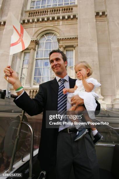 England captain Michael Vaughan and his daughter Talulah Grace wave to the crowd during England cricket team's Ashes victory bus parade from Mansion...