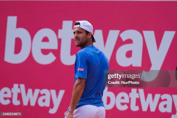 João Sousa of Portugal competes against Sebastian Baez of Argentine during the Millennium Estoril Open ATP 250 tennis tournament at Estoril Tennis...