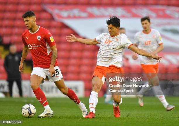 Blackpool's Kenny Dougall battles with Barnsley's Matty Wolfe during the Sky Bet Championship match between Barnsley and Blackpool at Oakwell Stadium...