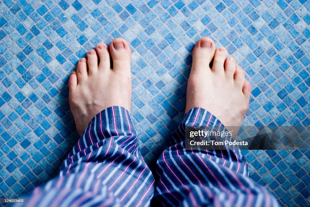 Pyjama feet on blue floor