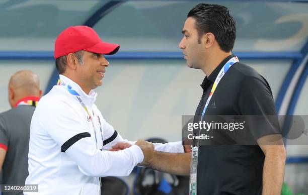 Foolad's coach Javad Nekounam greets Shabab's coach Mahdi Ali during the AFC Champions League group C match between Iran's Foolad and UAE's Shabab...