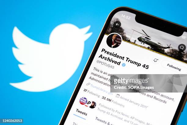 In this photo illustration, former U.S. President Donald Trump's archived Twitter account is shown on a phone screen with the Twitter logo in the...