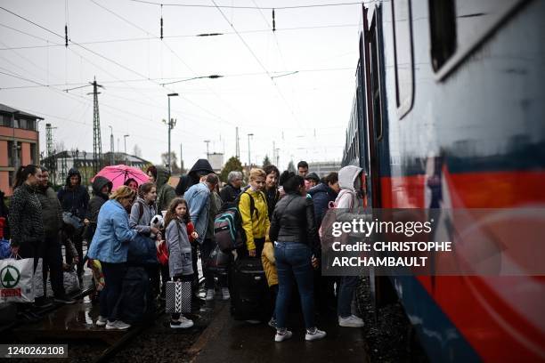 Ukrainian refugees board a train taking them back into Ukraine at the Zahony train station along the Ukrainian-Hungarian border, eastern Hungary on...