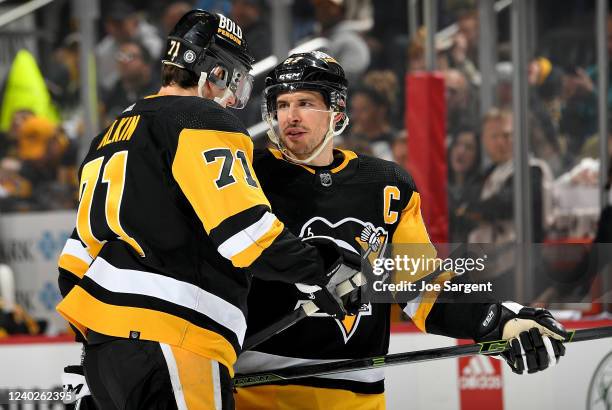 Sidney Crosby and Evgeni Malkin of the Pittsburgh Penguins talk before a face-off against the Edmonton Oilers at PPG PAINTS Arena on April 26, 2022...