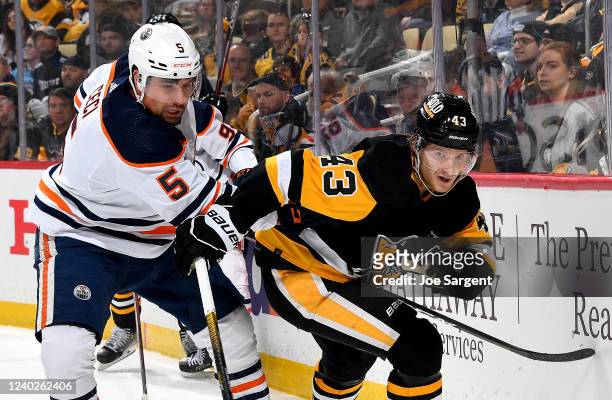 Danton Heinen of the Pittsburgh Penguins battles against Cody Ceci of the Edmonton Oilers at PPG PAINTS Arena on April 26, 2022 in Pittsburgh,...