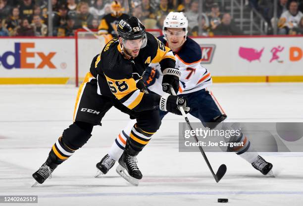 Kris Letang of the Pittsburgh Penguins handles the puck against the Edmonton Oilers at PPG PAINTS Arena on April 26, 2022 in Pittsburgh, Pennsylvania.