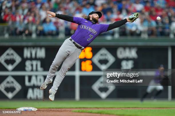 Brendan Rodgers of the Colorado Rockies cannot make the catch on a ball thrown by Ryan McMahon in the bottom of the second inning against the...