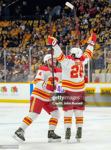 Dillon Dube celebrates his goal with Rasmus Andersson of the Calgary Flames against the Nashville Predators during an NHL game at Bridgestone Arena...