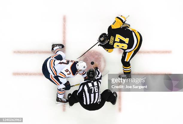 Sidney Crosby of the Pittsburgh Penguins takes a face-off against Connor McDavid of the Edmonton Oilers at PPG PAINTS Arena on April 26, 2022 in...