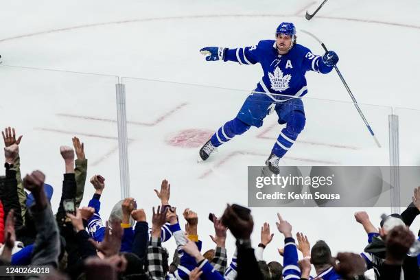 Auston Matthews of the Toronto Maple Leafs celebrates his 60th goal of the season during the third period against the Detroit Red Wings at the...