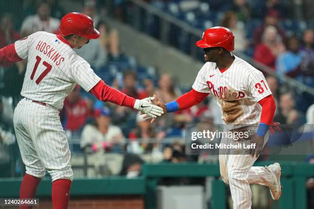 Rhys Hoskins of the Philadelphia Phillies celebrates with Odubel Herrera after Herrera scored a run in the bottom of the fourth inning against the...