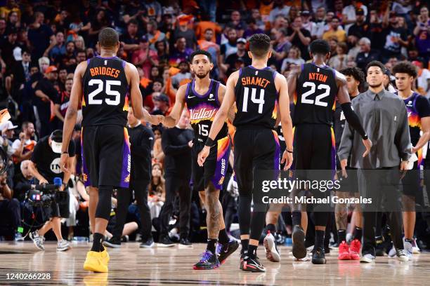 Mikal Bridges of the Phoenix Suns high fives Cameron Payne during Round 1 Game 5 of the 2022 NBA Playoffs on April 26, 2022 at Footprint Center in...