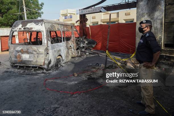 Police stands next a blast site a day after a suicide attack on a van near the Confucius institute which is the cultural programme that China...