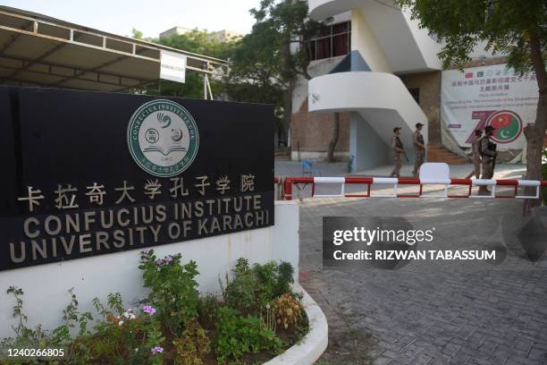 Rangers stand guard nearby the blast site a day after a suicide attack on a van near the Confucius institute which is the cultural programme that...