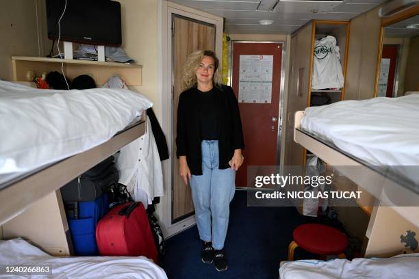 Ukrainian Irina Ivzhenko poses in her cabin, where she lives with her four children, aboard the Corsica Linea ferry "Mediterranee" in Marseille,...