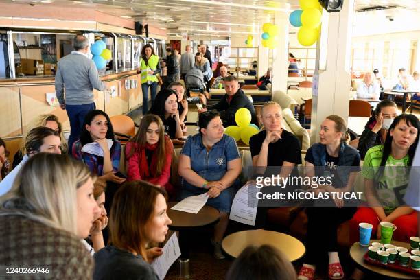 Ukrainian women attend a meeting about how to find a job in France aboard the Corsica Linea ferry "Mediterranee" in Marseille, southern France, on...