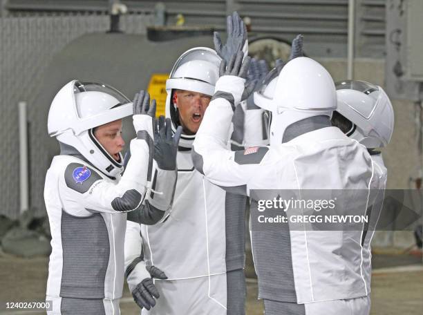 Crew-4 mission astronauts including Jessica Watkins and Bob Hines have an impromptu cheer to the success of their mission as they walk out of the...