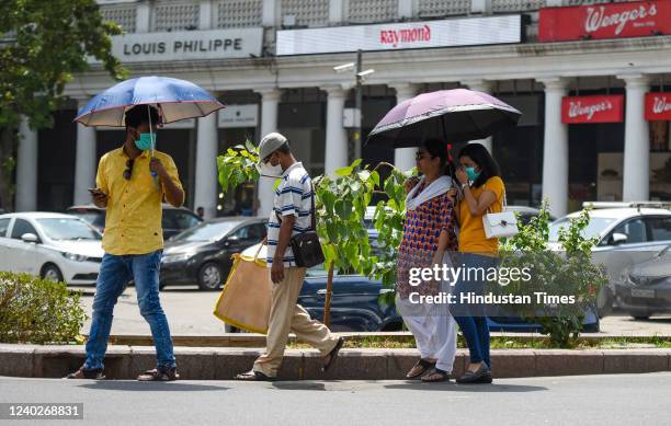 Pedestrians on a hot summer day at Connaught Place, on April 25, 2022 in New Delhi, India.