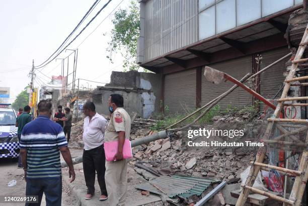 Police person investigation as two persons killed after the boundary wall of the house collapsed, at Keshavpuram in North West district on April 26,...