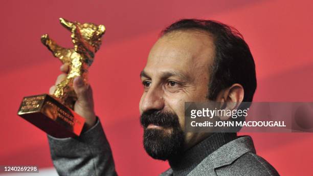 Iranian director Asghar Farhadi poses with the Golden Bear prize awarded for his film "Nader and Simin: A Separation" during a press conference after...